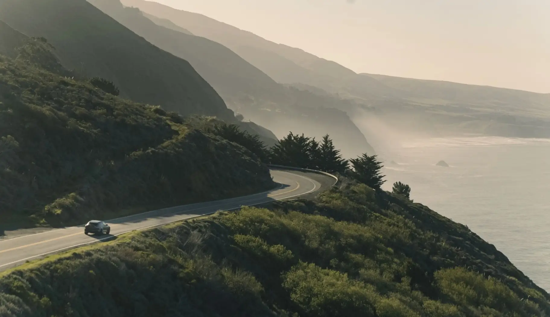 Aston Martin SUV driving along the coast